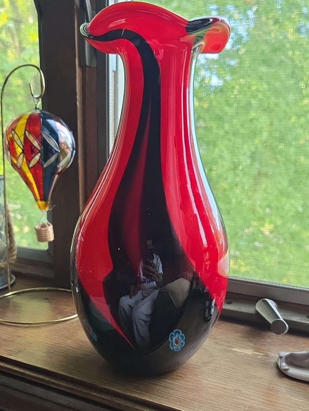 This striking vase appears to be a vintage mid-century Italian Murano